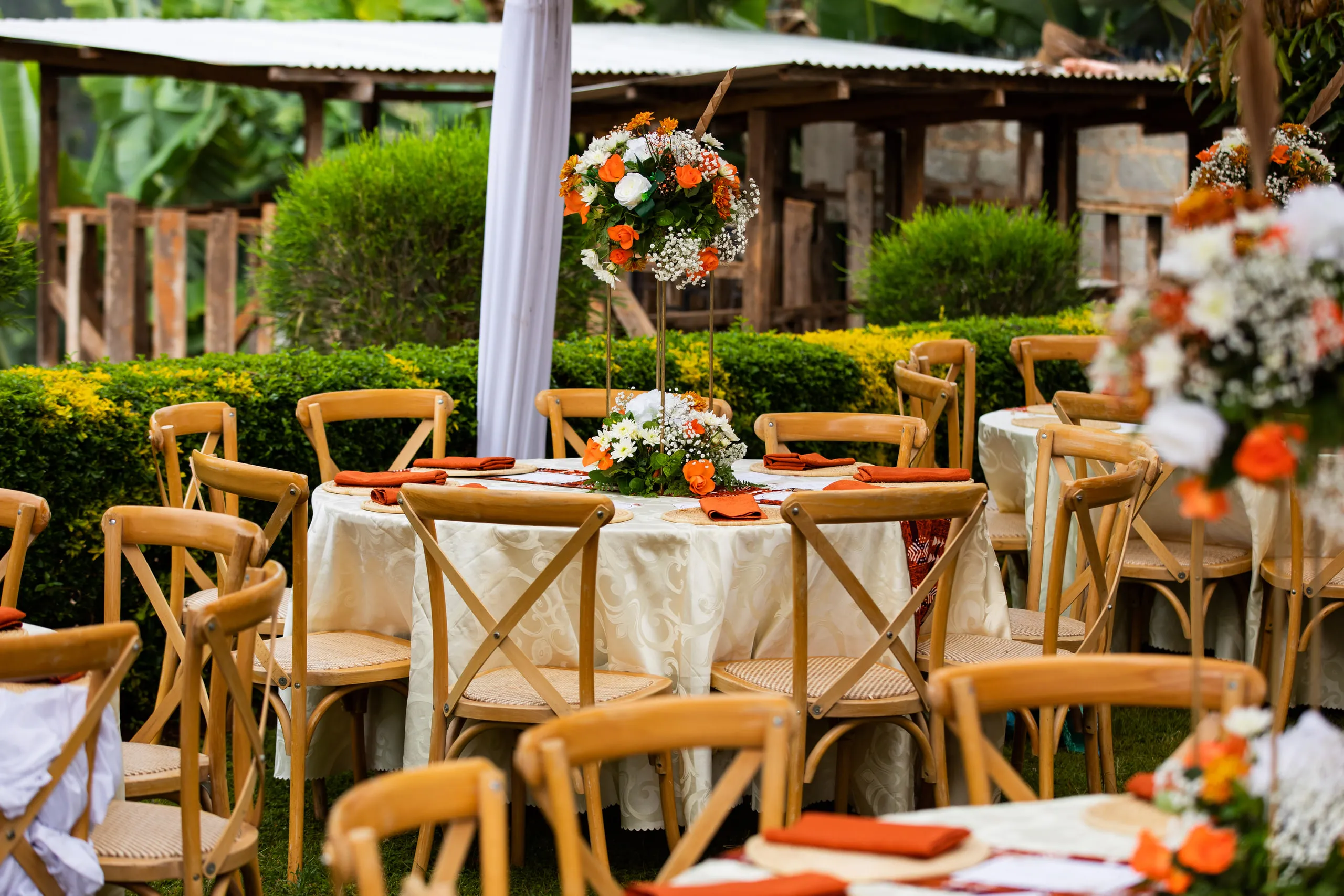 Reception tables set with orange and white flowers
