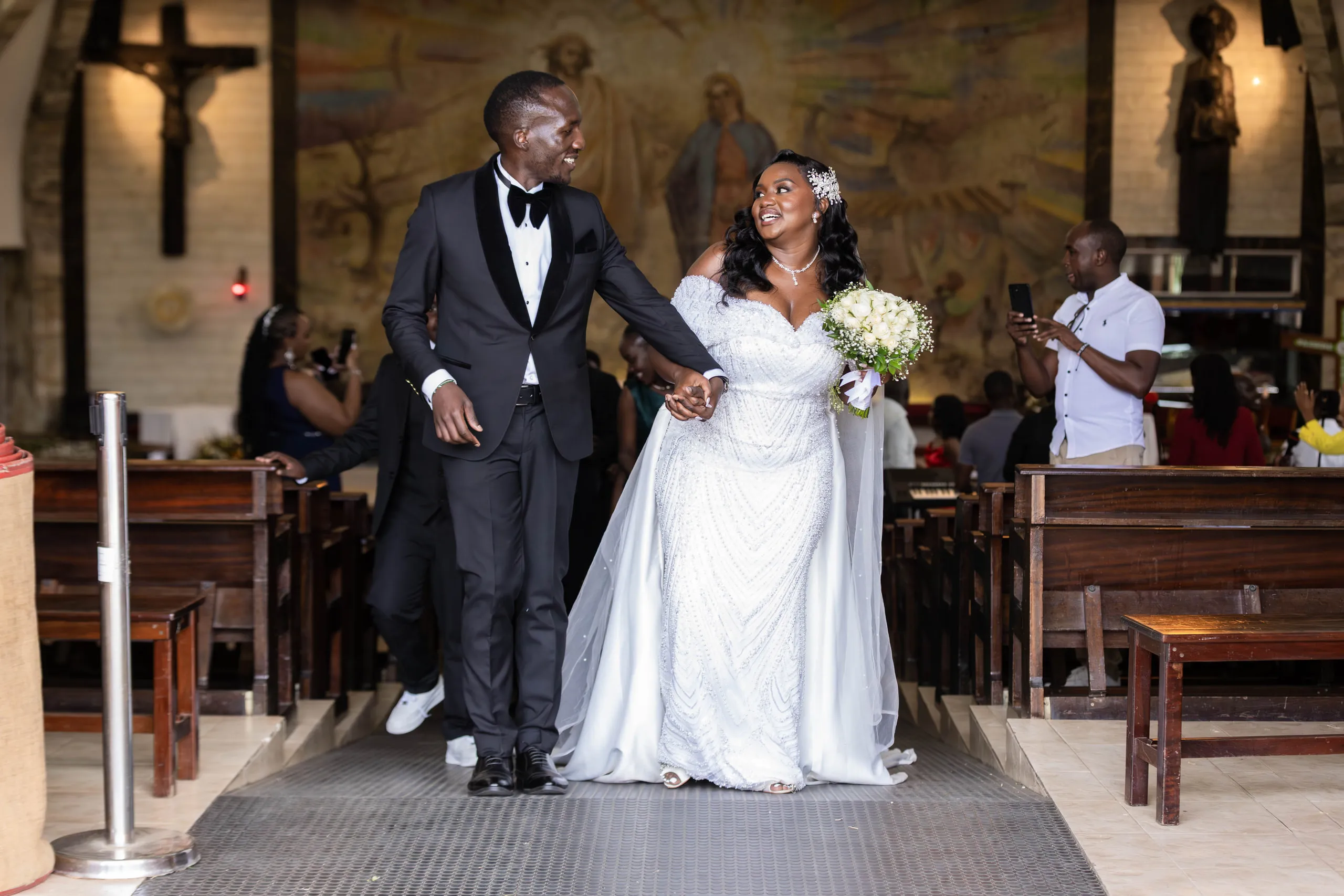 Bride and groom walking back down the church aisle