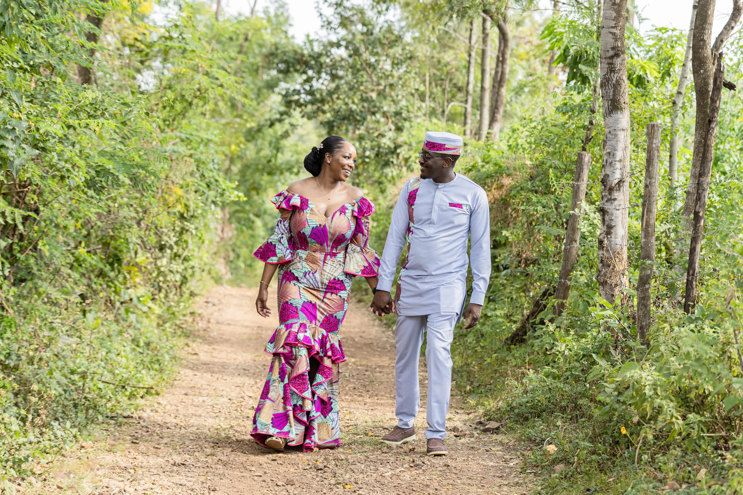 Couple walking hand in hand on a forest path