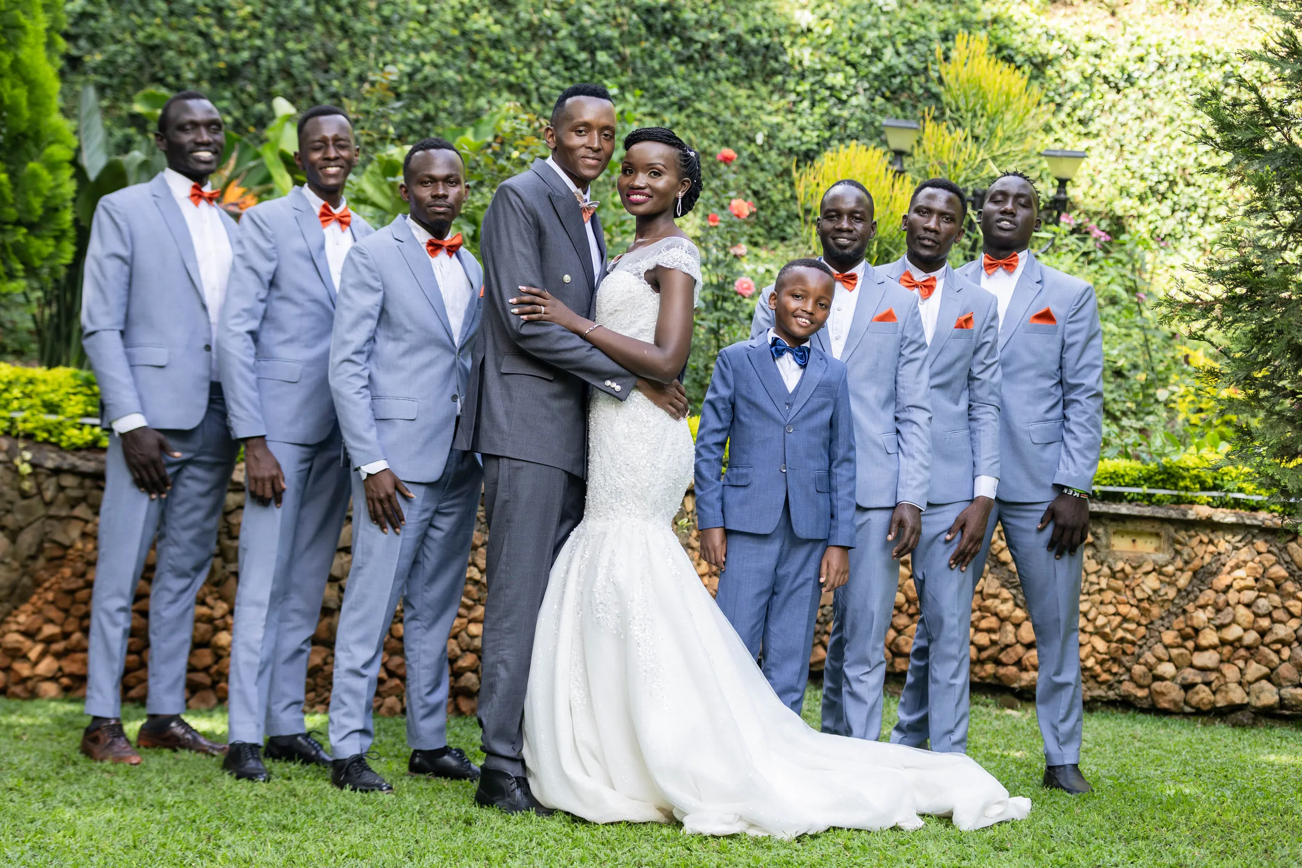 Groom holding the bride close among his groomsmen