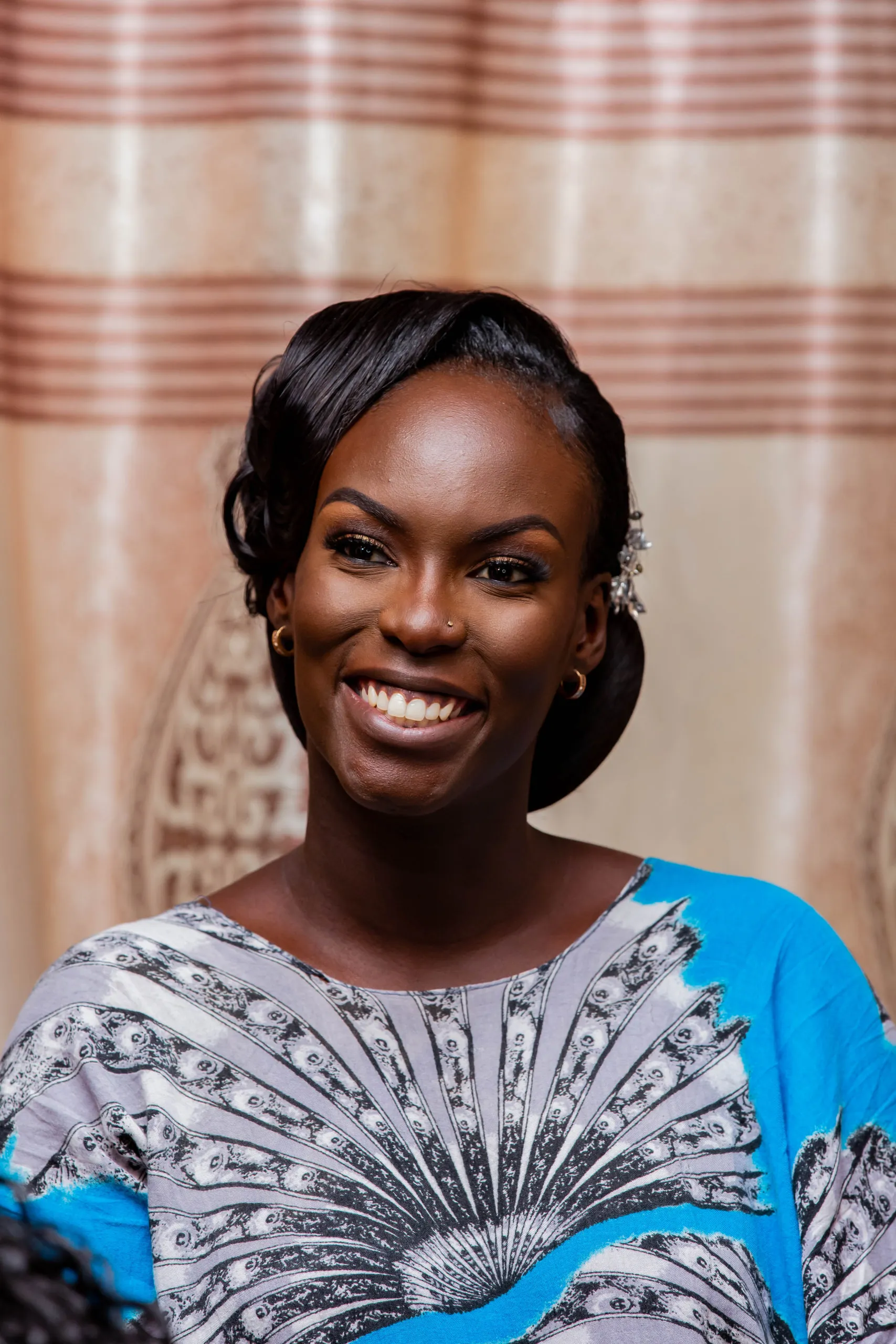 Bride smiling, her hair pinned in soft curls