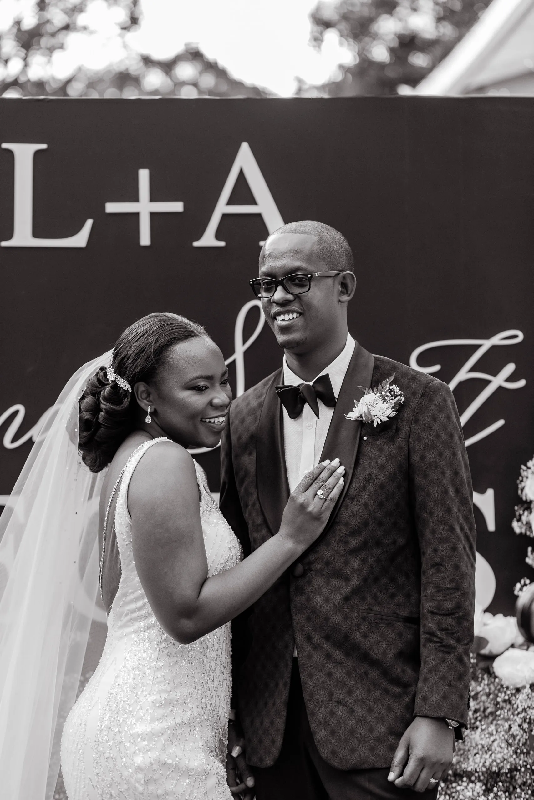 Bride resting her hand on the groom's chest, in black and white