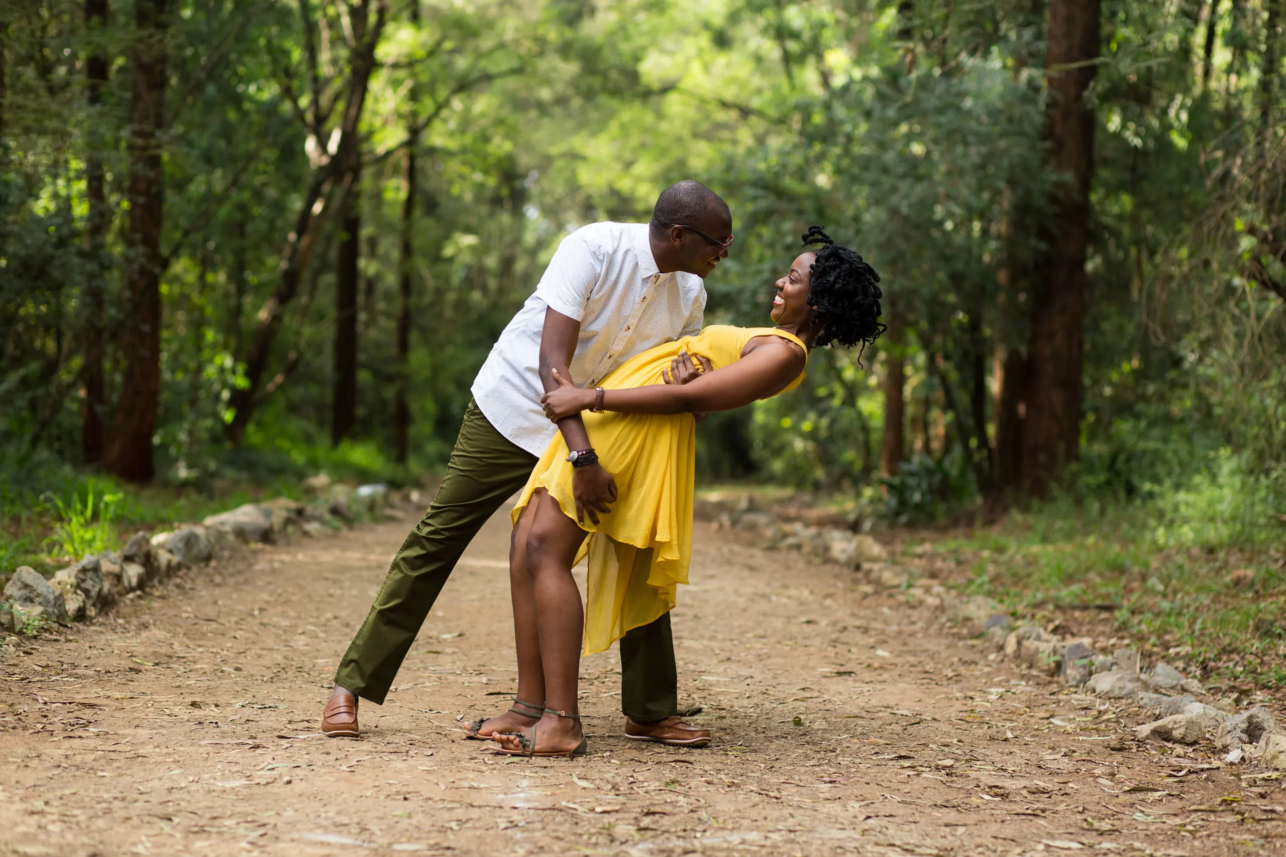 He dips his fiancée on a forest path, she in a yellow dress
