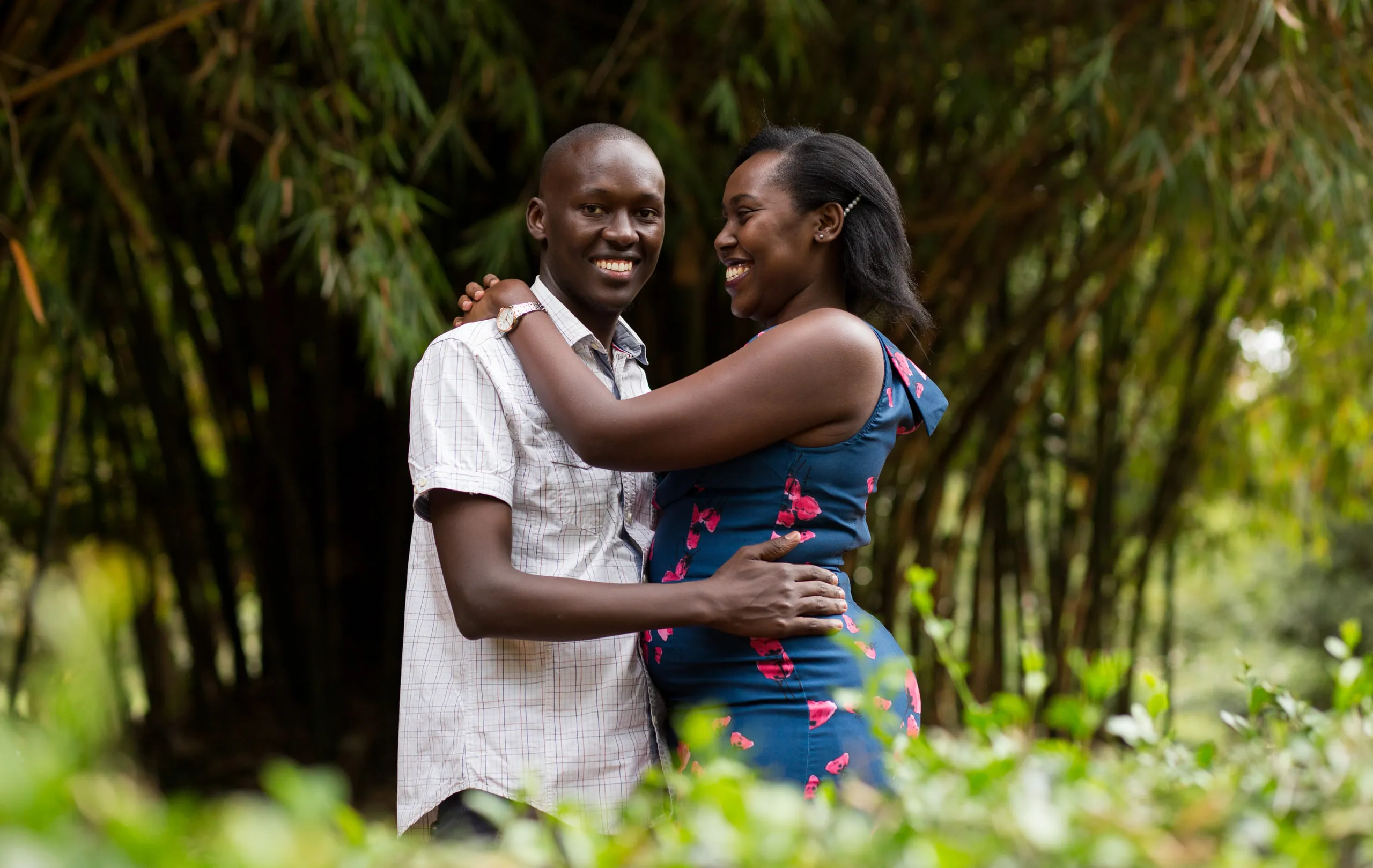 Couple laughing together among bamboo