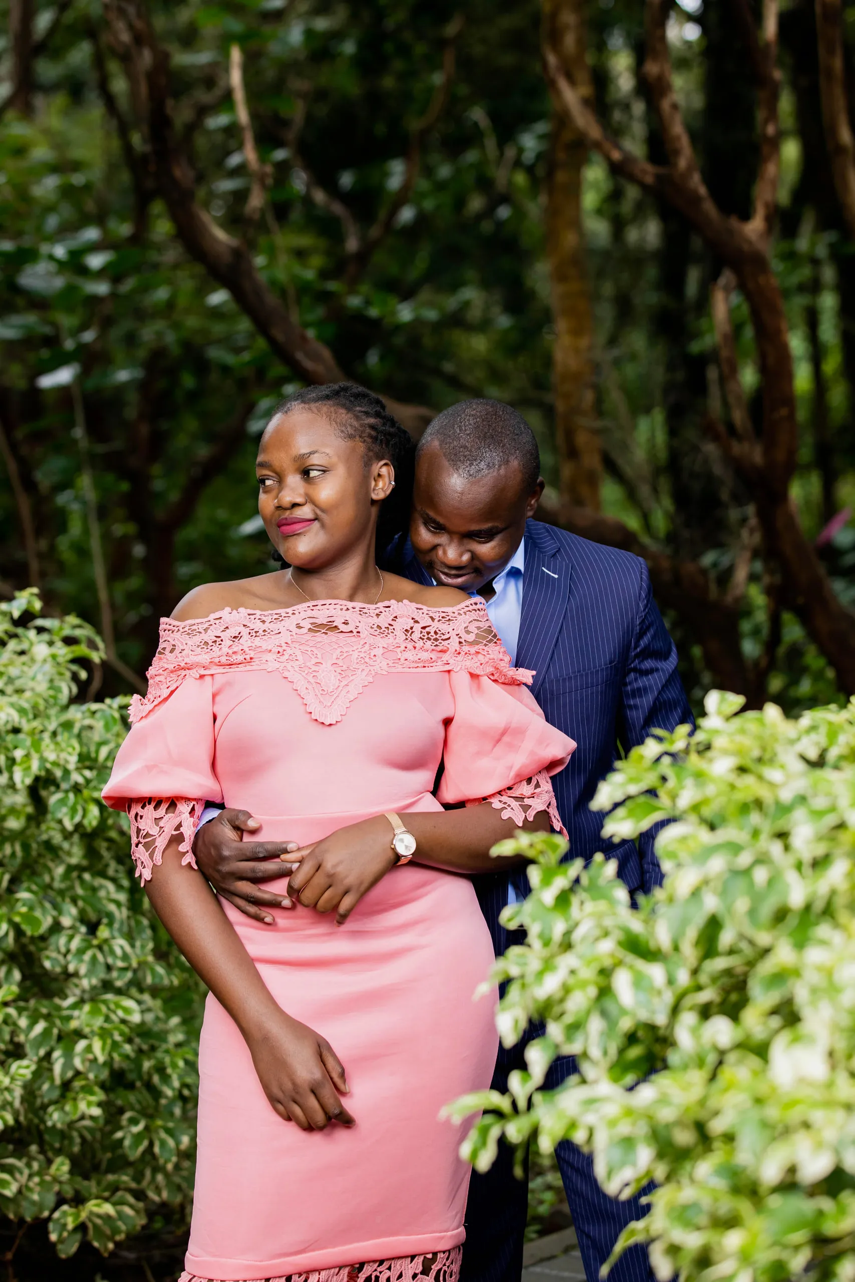 Couple in a garden, she in a pink dress